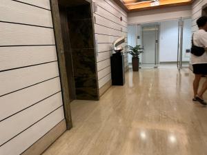 a woman walking down a hallway in a building at 2P Cool Home Tagaytay at SMDC Cool Suite Residences in Tagaytay