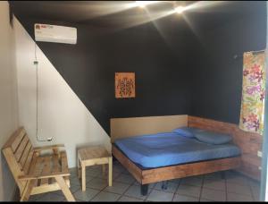 sypialnia z niebieskim łóżkiem i krzesłem w obiekcie Auberge-Cafe Tunisie w mieście Nawakszut