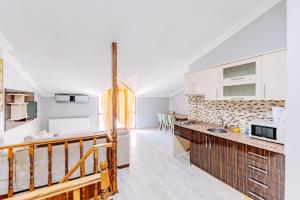 a kitchen and living room with a staircase in a house at Diamond Suites Residence in Istanbul