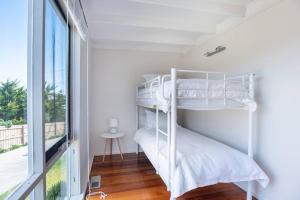 a bedroom with two bunk beds and a window at Casa Sorrento in Sorrento