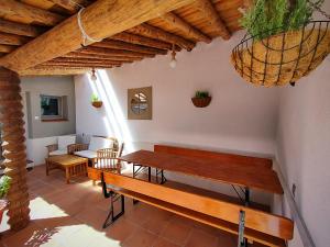 a room with benches and a table and chairs at Casa Rural El Caño in Nava del Rey