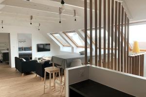 a living room with a table and some skylights at Kermorvan - pleine vue mer- parking et wifi - départ pour les îles in Le Conquet