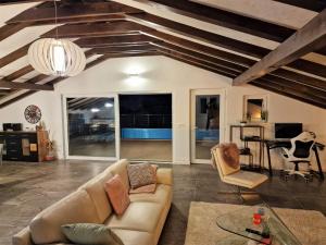 a living room with a couch and a table at Holiday House Nirvana in Bakarac