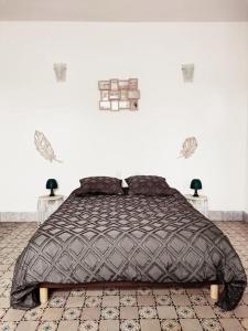 a bedroom with a large bed with two night stands at La ferme des sorciers in Agnez-lès-Duisans