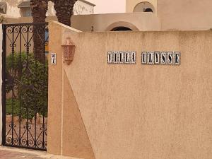 Villa Ulysse Djerba في ميدون: جدار مع علامة تقرأ فيلا كون