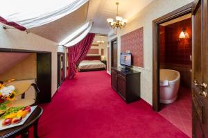 Habitación de hotel con pasillo de moqueta rosa, cama y TV. en Franz Hotel&Restaurant, en Ivano-Frankivsk