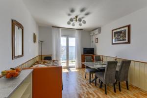 a kitchen and dining room with a table and chairs at Villa Fontana in Starigrad-Paklenica