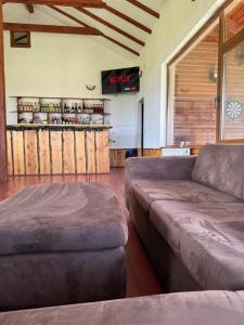 a living room with a couch and a counter at Cabana Chilii in Cîmpulung