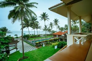 a view of the ocean from the balcony of a resort at Asokam Beach Resort in Kannur