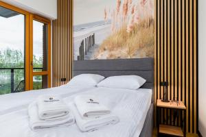 a bedroom with a bed with white towels on it at STAR Apartments Gdańsk - Gym & Sauna in Gdańsk