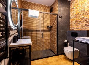 a bathroom with a shower and a sink and a toilet at STAR Apartments Gdańsk - Gym & Sauna in Gdańsk