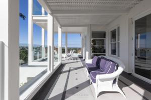 a porch with a purple couch and chairs on it at Brisbane Hamilton Hill With Panorama View in Brisbane