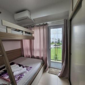 a small room with a bunk bed and a window at 2P Cool Home Tagaytay at SMDC Cool Suite Residences in Tagaytay