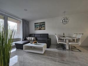 a living room with a couch and a table at Apartmány Urban in Poprad