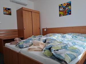 a bedroom with a bed with towels on it at Apartmán PalacKY in Kyjov