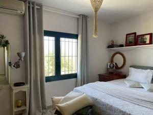 a bedroom with a bed and a window at Full of Cretan Nature Apartment in Stavrákia