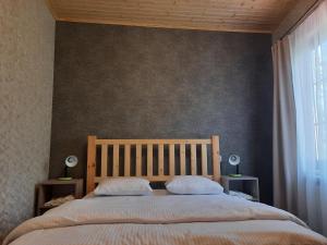 a bedroom with a large bed with two pillows at Light house Dilijan in Dilijan