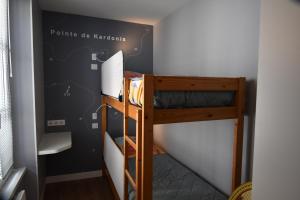 a bedroom with two bunk beds in a room at Hotel Atlantique in Le Palais