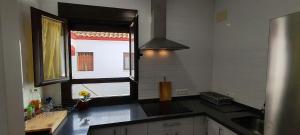 a kitchen with a sink and a window at Apartamento Karmo in Carmona