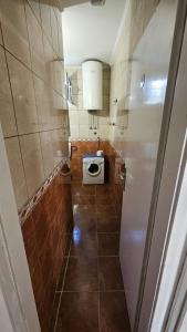 a bathroom with a toilet and a sink in it at Radenović, soba in Budva