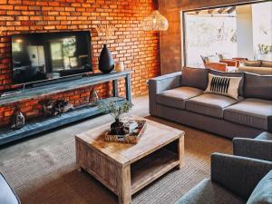 a living room with a couch and a fireplace at Rhino's Rest Luxury Villa in Hoedspruit