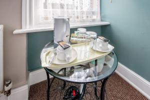 a glass table with a blender on it in a room at The Kings Arms in London