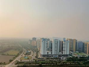 a view of a city with tall buildings at Sandal suite by Mulberry Homestays in Noida