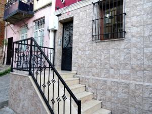 a black door on a stone building with stairs at Istanberry - Dream Apartments in Istanbul