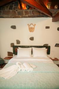 A bed or beds in a room at Areto Butik Otel