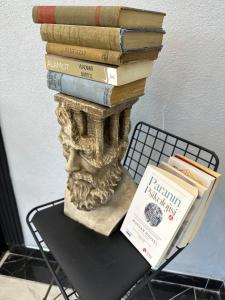 a pile of books sitting on top of a table at pilot hotel in Arnavutköy