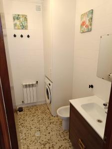 a bathroom with a toilet and a sink at Piso Frente al Mar, O Barqueiro 2 in O Barqueiro