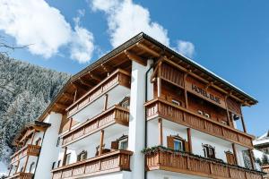 a building with wooden balconies on the side of it at Hotel Else in Selva di Val Gardena