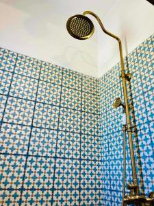a shower in a bathroom with a blue and white tiles at Vintage lover's getaway in Antiparos +48 photos