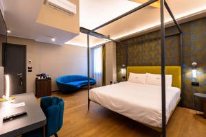 a hotel room with a bed and a desk and a desk at Hotel Touring in Bologna