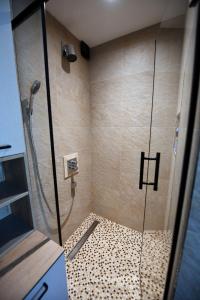 a shower with a glass door in a bathroom at Villa Luxury Medjuvrsje in Međuvršje +27 photos