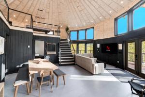 a large living room with a table and a couch at Skyline Yurt: Hot Tub~Wood Stove~WiFi~EVcharger in Front Royal
