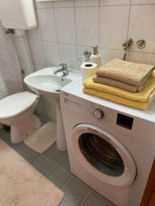 a washing machine in a bathroom with a toilet and a sink at Minja in Vrnjačka Banja +15 photos
