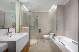 a bathroom with a sink and a toilet and a shower at Shenzhen Futian Crowne Plaza Hotel,Near by Futian Station and Coco Park, Outdoor Heated Pool in Shenzhen