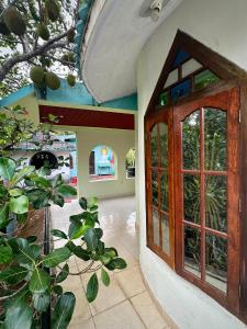 an entrance to a house with a wooden door at Rams Gratitude Inn in Varkala +37 photos