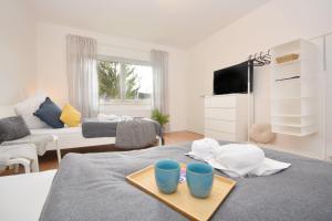 a living room with a table with two blue cups on it at RT02-FW Wohnung in Schwanstetten in Schwanstetten