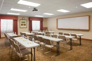 a conference room with tables and chairs and a whiteboard at Country Inn & Suites by Radisson, Ithaca, NY in Ithaca