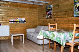 a living room with a couch and a table at Le Clos du Clocher in Gueudecourt