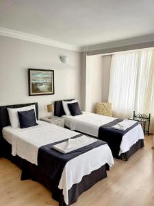 a hotel room with two beds and a window at Villa Sophia Marmaris in Marmaris