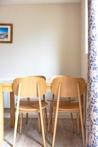 two chairs and a table in a room at Gwithian Holidays in Hayle