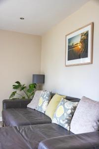 a couch in a living room with a picture on the wall at Gwithian Holidays in Hayle