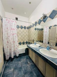 a bathroom with two sinks and two mirrors at Main Market Square Apartments in Krakow