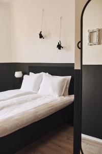 a bedroom with a large bed with white pillows at Hotell Slottsgatan in Oskarshamn +23 photos