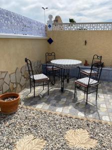 a patio with a table and chairs on a patio at Ideal Location 3 Bed 3 Bath Villa With Pool On Camposol Sect B Close To Amenities in Mazarrón