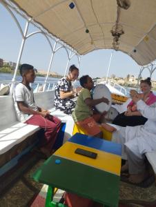 a group of people sitting on a boat at charming nubian guest house in Aswan
