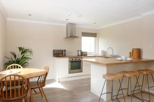 a kitchen with a counter and a table and chairs at Gwithian Holidays in Hayle